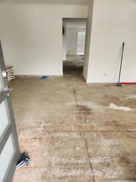 A bare subfloor swept and prepared for a new tiled floor